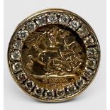 A 9ct gold ring set with a George & Dragon panel, and white coloured stones, gross weight