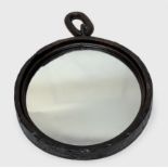 An 18th/19th century wrought iron ring converted to a circular wall mirror, with chain link