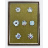 A collection of six white-metal and enamel Ambulance Service and one Fire Brigade cap badges for