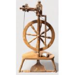 A modern turned wooden wool-spinning wheel, 103cm tall