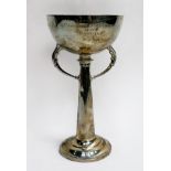 A silver presentation trophy cup of automobile interest, in the Arts & Crafts style and of elongated