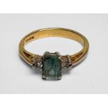 WITHDRAWN: An 18ct yellow gold ring, set with a emerald-cut aquamarine to the centre, flanked by two