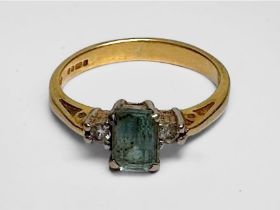 WITHDRAWN: An 18ct yellow gold ring, set with a emerald-cut aquamarine to the centre, flanked by two