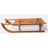 A 'Gloco' child's sledge, cronstructed from beechwood and laminate with metal runners, made in