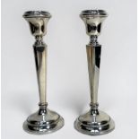 A pair of loaded silver candlesticks by Sanders & Mackenzie, hallmarked Birmingham, 1970, gross