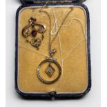 An Edwardian 9ct yellow gold garnet and seed-pearl scrollwork pendant, together with a 9ct yellow