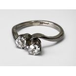 WITHDRAWN: A platinum two-stone crossover ring, set with two Victorian cut diamonds, estimated total