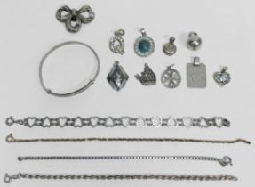 A collection of assorted silver and white metal pendants, bangles and chains, gross weight of silver