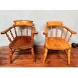 Two early 20th century elm and beech captains chairs, of typical form, raised on turned supports