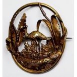 A yellow metal, tests as 14ct gold oval brooch, pierced and worked with an Emu amidst foliage,