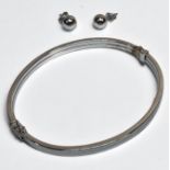 A 9ct white gold hinged bangle, with figure 8 safety catch, and a pair of 9ct white gold ball