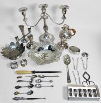 A small collection of assorted silver including spoons, two napkin rings and sugar tongs, gross
