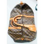 A Louis Vuitton monogram holdall, 40, with tan leather luggage tag, brass hardware, zip broken.