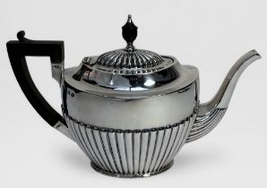 A Victorian silver teapot by J Sherwood & Sons, with half-reeded decoration to sides and lid,