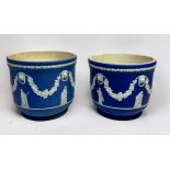 Two similar dark blue Wedgwood Jasper 'dip' jardinières / planters, decorated in relief with lion