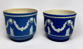 Two similar dark blue Wedgwood Jasper 'dip' jardinières / planters, decorated in relief with lion
