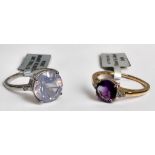 A 10ct yellow gold dress ring, set with a round faceted amethyst to the centre, and three small