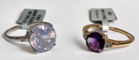 A 10ct yellow gold dress ring, set with a round faceted amethyst to the centre, and three small