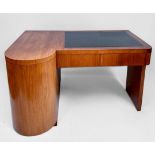 An Art Deco walnut veneered desk with black tooled leather scribe to top, above two frieze