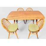 An Ercol blonde elm plank top rectangular dining table, raised on squared, tapering supports,