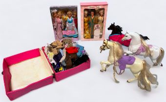A collection of assorted Barbie and Ken dolls and two white horses by Mattel, dressed in various