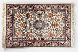A small hand-knotted Persian rug, worked with a central medallion in garden with vases of flowers