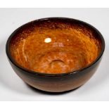 A Scottish Monart glass bowl in deep red/orange finish, 23cm diameter