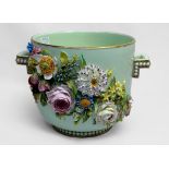 A porcelain twin-handled pail, ornately encrusted with relief moulded flowers to each side, 18.5cm