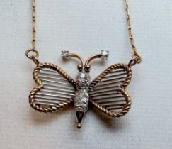 A 14ct yellow and white gold butterfly pendant and chain, the butterfly is set with small diamonds