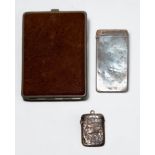 A silver calling card case and a silver vesta, together with a white metal and leather cigarette