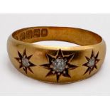 An Edwardian 18ct gold ring, star set with three diamonds, total estimated weight 0.10cts,