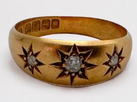 An Edwardian 18ct gold ring, star set with three diamonds, total estimated weight 0.10cts,