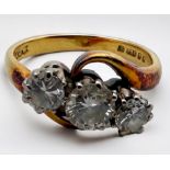 An 18ct yellow gold three-stone diamond ring, set with three round brilliant cut diamonds, estimated