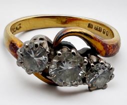 An 18ct yellow gold three-stone diamond ring, set with three round brilliant cut diamonds, estimated