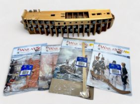 A Del Prado 'War At Sea - Build The Victory' with part-built hull, planked deck and metal gun ports,