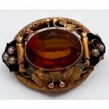 A yellow metal, tests as 14ct gold, brooch, set with a large oval-shaped faceted stone to the