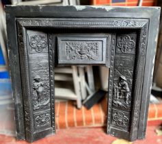 A Victorian cast iron fire insert, moulded in relief with figures, 98cm tall x 99cm wide, with