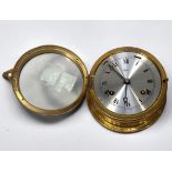 A brass cased bulkhead clock by Barigo, with alarm function and silvered dial denoting hours, 15cm