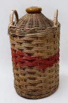 A Royal Navy Pusser's Rum stoneware flagon, with wicker outer sleeve (lacking contents) together