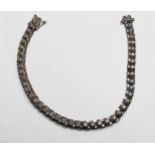 A 9ct white gold line bracelet, set with 42 x round brilliant cut diamonds, total estimated weight