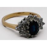 An 18ct yellow gold sapphire and diamond ring, set with an oval sapphire to the centre, surrounded