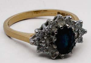 An 18ct yellow gold sapphire and diamond ring, set with an oval sapphire to the centre, surrounded