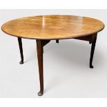 A mid-18th century mahogany drop-leaf table, of oval form, with double gateleg, on turned and