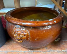 A large pottery jardiniere / planter, foo dog faces moulded in relief, lipped rim, brown gloss