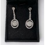 A pair of 18ct white gold and platinum drop earrings, each one rub-over , with six old-cut