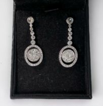 A pair of 18ct white gold and platinum drop earrings, each one rub-over , with six old-cut