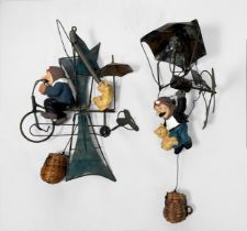 Two unusual metal and clay hanging figures, modelled as a man and cat with a propelled parachute and