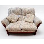 A Joynson Holland two-seater sofa with cream foliate upholstery, approx. 145cm wide