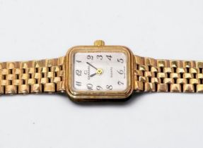 A ladies 9ct gold Garrard wristwatch, the rectangular white enamel dial with Arabic numerals