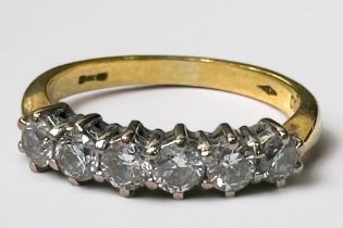 An 18ct yellow gold ring, claw set with six round brilliant cut diamonds, total diamond weight 1.